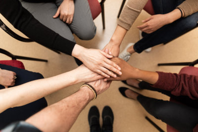a group of people hands in the center