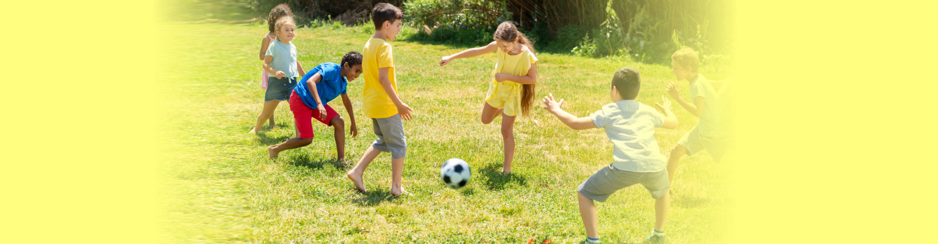 a group happy children playing football together